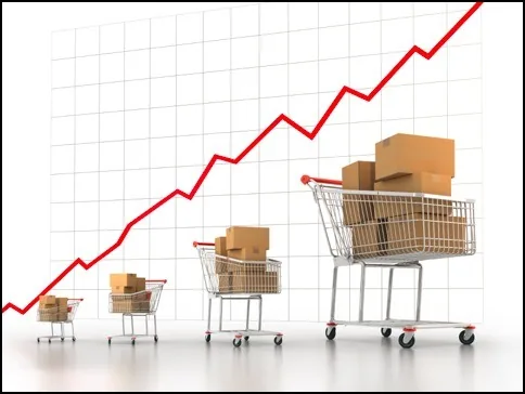 Shopping trolleys with more and more parcels in front of a rising curve